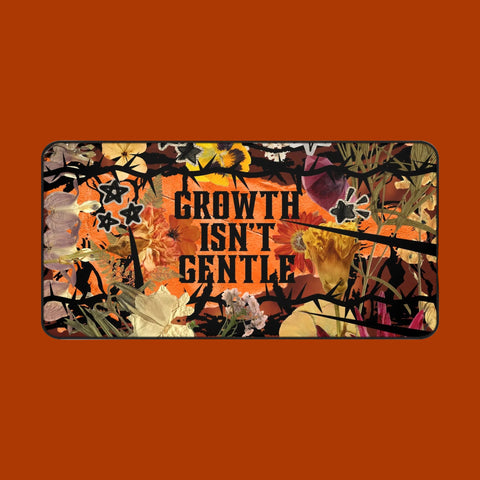 "growth isn't gentle" desk mat