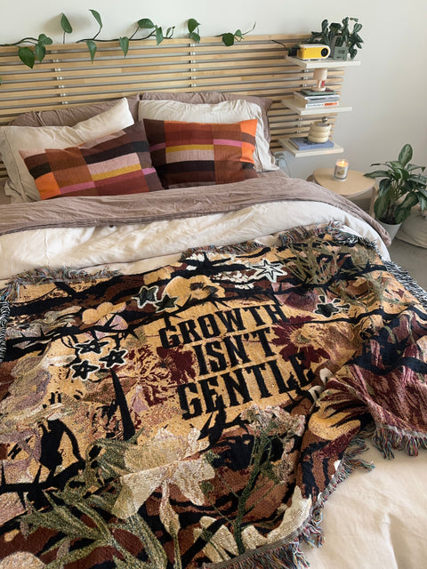 "growth isn't gentle" woven blanket