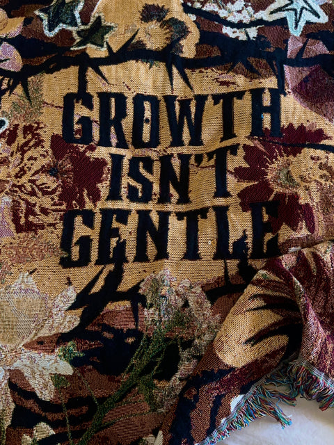 "growth isn't gentle" woven blanket
